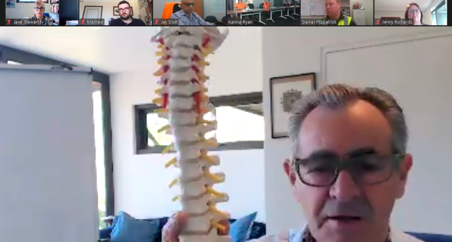 zoom call showing a spine replica, explaining musculoskeletal disorders